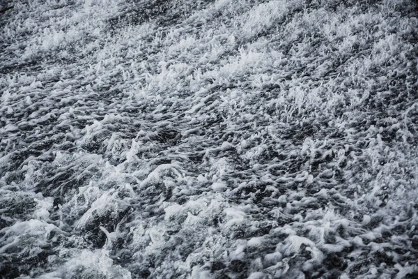 Wild swirling water caught on high speed shutter. water released from irrigation dam.
