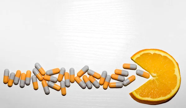 Slice Orange Fruit Eating Many Capsule Pills Isolated White Table — Stock Photo, Image