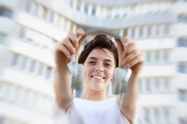 Happy Girl Holding White Big Headphones Smiling White House Background — Stock Photo, Image