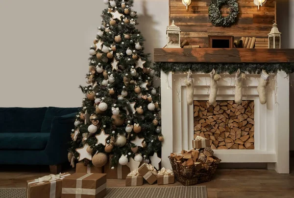 Interior eco style. decorated interior of couch and Christmas tree, modern and cozy. happy new year and merry christmas. Design room with Christmas tree, sofa and the fireplace.