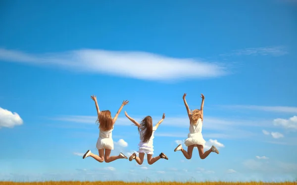 Atrás Vista Trasera Tríos Mujeres Saltando Fondo Azul Cielo Campo —  Fotos de Stock