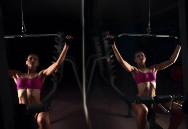 Spor salonunda çalışan sağlıklı genç bir kadın. Sağlıklı yaşam tarzı kavramı.