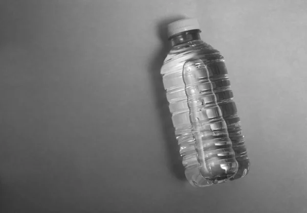 plastic bottle of sparkling water isolated on paper background. empty copy space for inscription.