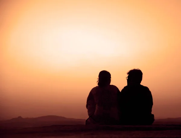 Back View Silhouette Traveler Couple Sitting Together Looking Beautiful Sunrise Stock Photo
