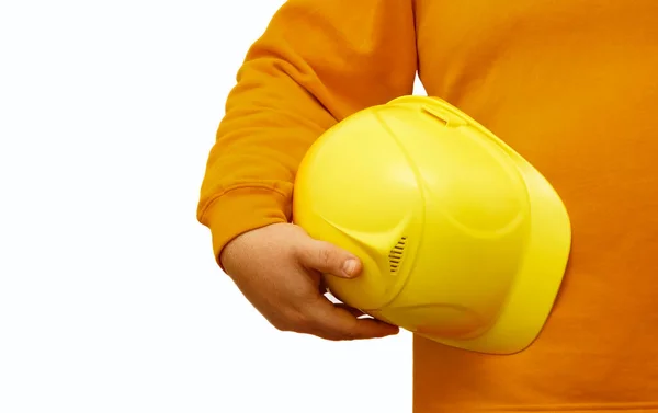 在孤立的背景下手持黄色头盔的工人或工程师 没有脸 — 图库照片