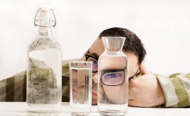 surreal portrait of a strange man looking through glasses of water. man looking through glass glasses of water with reflections and distortions. isolated on white background.