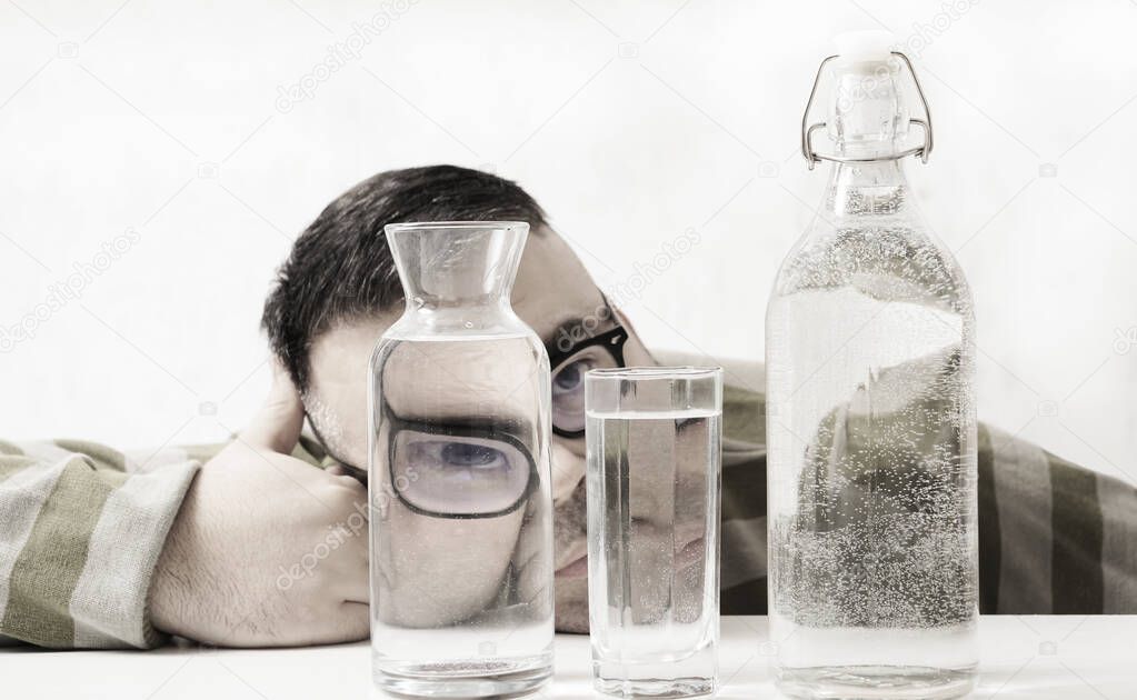 surreal portrait of a strange man looking through glasses of water. man looking through glass glasses of water with reflections and distortions. isolated on white background.