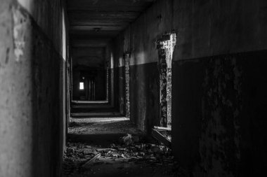 Abandoned corridor in dark industrial building. Creepy corridor. Mystical empty tunnel in abandoned house in perspective. 