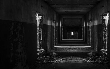 Abandoned corridor in dark industrial building. Creepy corridor. Mystical empty tunnel in abandoned house in perspective. 