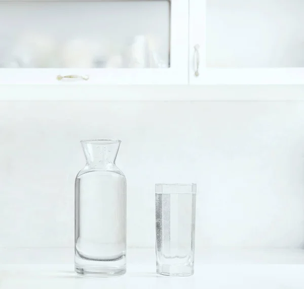 Jar Bottle Water Full Transparent Glasses White Table — Zdjęcie stockowe