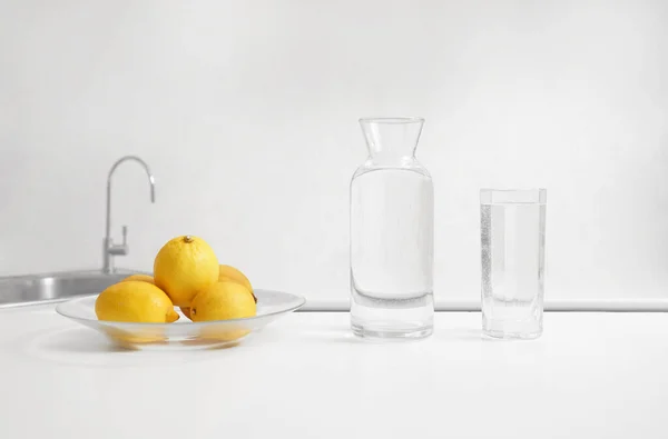 Fresh Lemons Glass Bottle Pure Water Standing Wooden Table Modern — Stockfoto