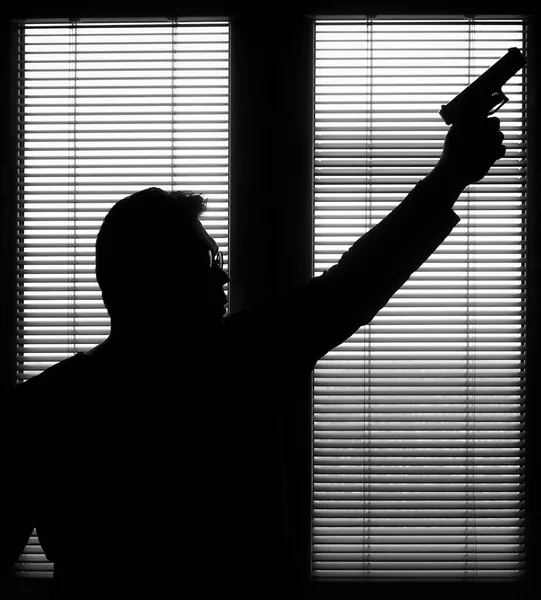 Man Gun Standing Window Blind Ready Protect Himself Another Bad —  Fotos de Stock