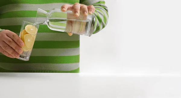 Man Pouring Water Bottle Transparent Glass Background Kitchen Interior Face — Foto de Stock