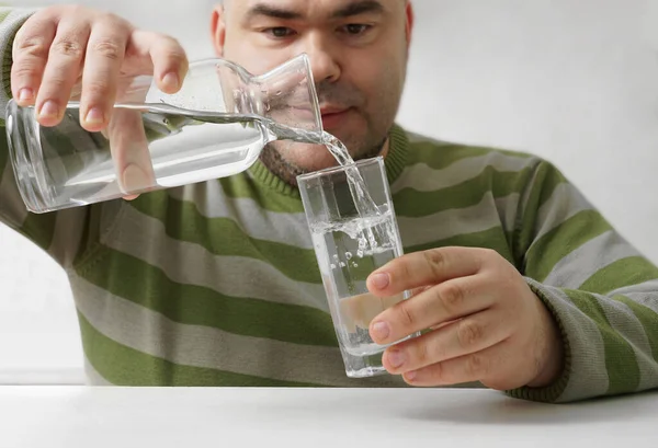 Middle Aged Man Pouring Water Bottle Glass Background Kitchen Interior — Fotografia de Stock