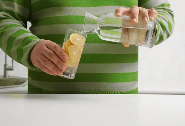 Man Pouring Water Bottle Transparent Glass Background Kitchen Interior Face — Zdjęcie stockowe