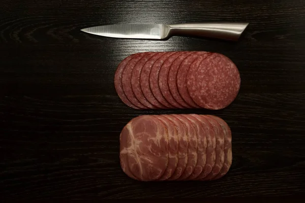 Sliced Salami Iron Knife Chopping Board Isolated Black Wooden Table — Stock Photo, Image