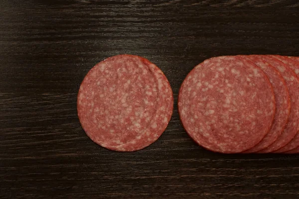 Top View Smoked Salami Sausage Slices Isolated Black Wooden Table — Stock Photo, Image