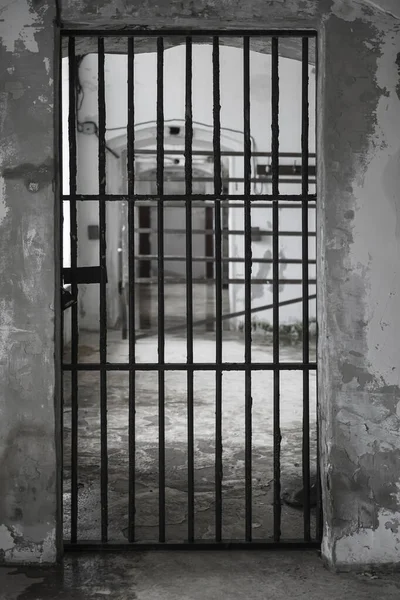 Prison closed door. Metal bars in jail. Window in old prison cell. Medieval prison with iron bars. Security grids. Prisoner view. Rods on a locked gate in castle. Barred doors. Security grille