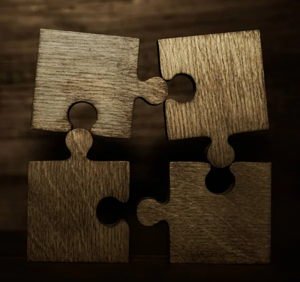Four Brown Pieces Puzzle Wooden Table Empty Copy Space Inscription — Stock Photo, Image