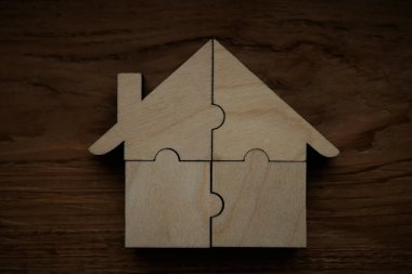  Tahta arka planda dört parçadan yapılmış ahşap bir ev.. 