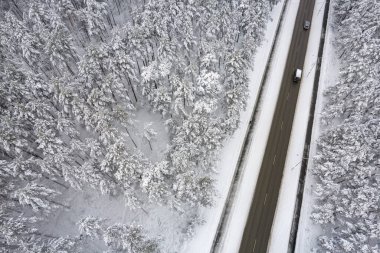 Dağlarda serin karlı kara yol ve ağaçlar
