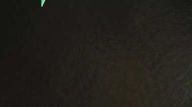 Aerial drone view of group of people kayaking in the river at sunset. Tourists in boats doing water sport during summer holidays on sea. Paddling kayakers in evening. Healthy lifestyle Active travel 