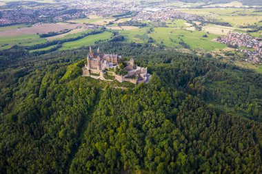Hohenzollern Kalesi 'nin yaz aylarında Swabian Alpleri' ndeki orman tepesindeki insansız hava aracı görüntüleri. Eski Alman Burg 'unun manzaralı görüntüsü. Stuttgart civarındaki ünlü Gotik Peri Masalı