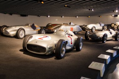 Stuttgart, Germany - July 5 2022: Historic collection of Mercedes racing cars and other brand in Mercedes-Benz Welt museum. Presentation of roadsters, AMG, silver arrows and 300 SL with gullwing doors
