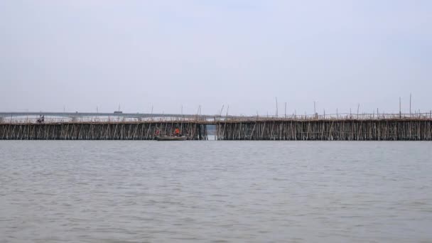 Small Fishing Boat Passing Bamboo Bridge Motorbikes Crossing — Stock video