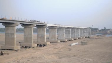 Construction crews working on the span of the bridge under construction 
