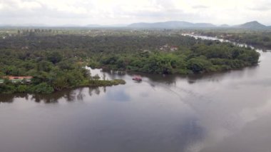 aerial drone shot of a small ferry sailing on a distributary channel
