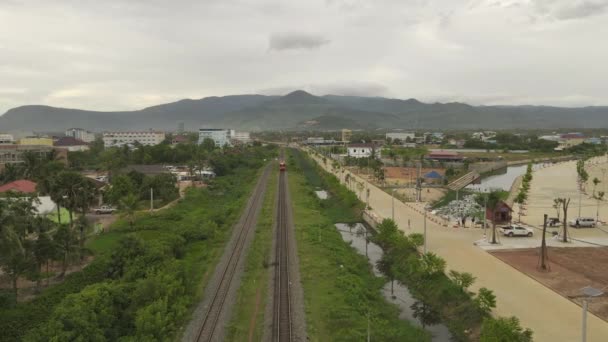 Forward Aerial Drone Footage Passenger Train Rolls Small City — Stockvideo