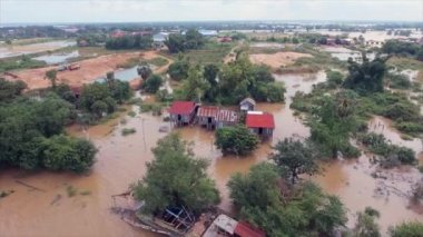 Aerial drone shot of flooding along the river inundated rural houses and agricultural fields