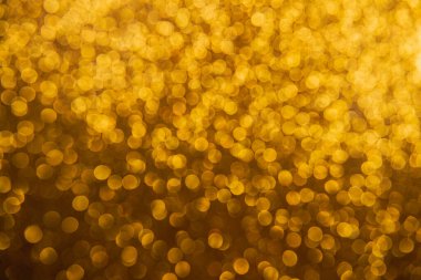 Oval sarı nesnelerden yapılmış doku. Etki, simli yüzeyi odaklanmadan makro ölçekte fotoğraflayarak elde edildi..