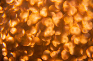 Oval sarı nesnelerden yapılmış doku. Etki, simli yüzeyi odaklanmadan makro ölçekte fotoğraflayarak elde edildi..