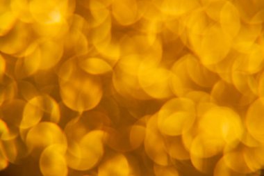 Oval sarı nesnelerden yapılmış doku. Etki, simli yüzeyi odaklanmadan makro ölçekte fotoğraflayarak elde edildi..