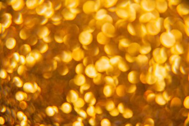 Oval sarı nesnelerden yapılmış doku. Etki, simli yüzeyi odaklanmadan makro ölçekte fotoğraflayarak elde edildi..