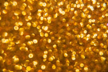 Oval sarı nesnelerden yapılmış doku. Etki, simli yüzeyi odaklanmadan makro ölçekte fotoğraflayarak elde edildi..