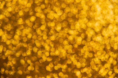 Oval sarı nesnelerden yapılmış doku. Etki, simli yüzeyi odaklanmadan makro ölçekte fotoğraflayarak elde edildi..