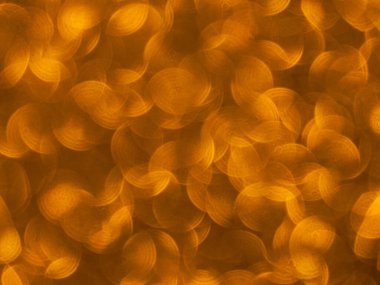 Oval sarı nesnelerden yapılmış doku. Etki, simli yüzeyi odaklanmadan makro ölçekte fotoğraflayarak elde edildi..