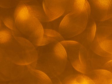 Oval sarı nesnelerden yapılmış doku. Etki, simli yüzeyi odaklanmadan makro ölçekte fotoğraflayarak elde edildi..