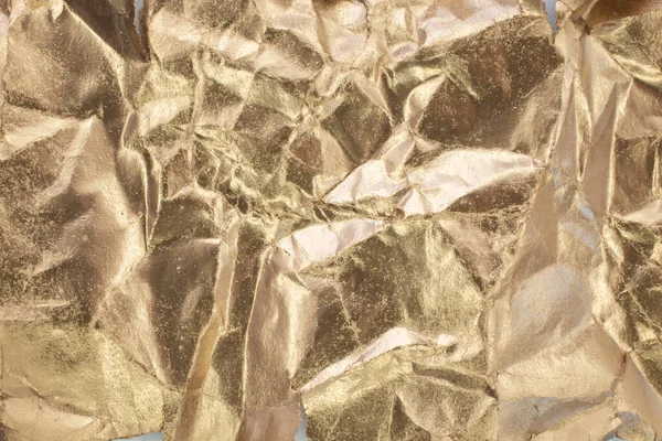 Golden vintage paper wrinkled, close up abstract background