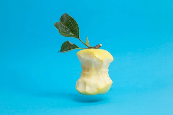 Eaten Golden Delicious Apple Core Leaves Levitating Blue Background — Stockfoto