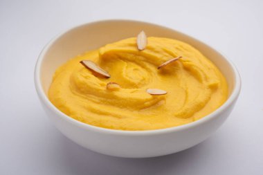 Amrakhand is an Alphonso flavoured Yogurt or Shrikhand, Popular Indian sweet served with dry fruits & Saffron clipart