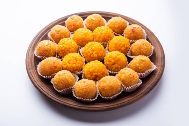 indian sweet moticho or laddoo or Bundi laddu made of gram flour very small balls or boondis which are deep fried and soaked in sugar syrup before making balls clipart