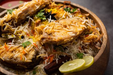 Otantik Balık Biryani beyaz tabakta ya da handi 'de servis edilir.