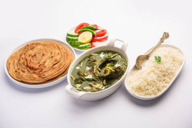 Palak Gosht ya da koyun eti köri, Hint usulü ıspanak ve körili kuzu pirinçli ve laccha paratha ile servis edilir.