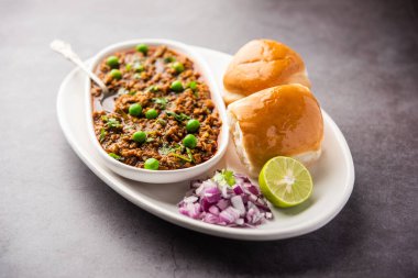 Kheema Pav ya da Hint Baharatlı Kıyma ya da Kuzu eti, yeşil bezelyelerle süslenmiş ekmek ya da kulcha ile servis edilir. Dengesiz bir arka plan. Seçici odak