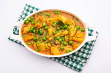 Aloo mırıldanan Hint alt kıtasında baharatlı kremalı domates sosunda patates ve bezelyeden yapılan bir Punjab yemeğidir.