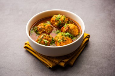 Veg Kofta Curry is an exotic Indian gravy dish made from mix vegetable dumplings dunked in a onion-tomato based gravy